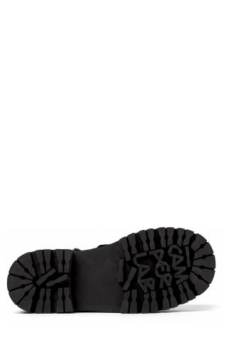 The soles of Eki Black long calf hair boots