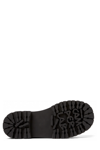 The soles of Eki Blue long calf hair boots